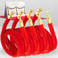 Four coiled red velvet ropes with gold clasps for VIP event barriers